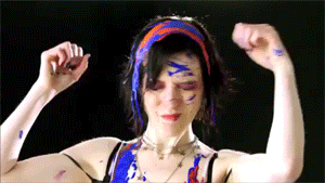 gif: from the video, Amber shakes a mess of paint from her hair